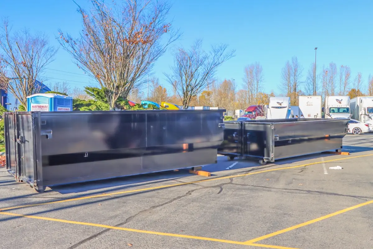 Professional dumpster rental service with roll-off container on residential driveway in Highland Heights